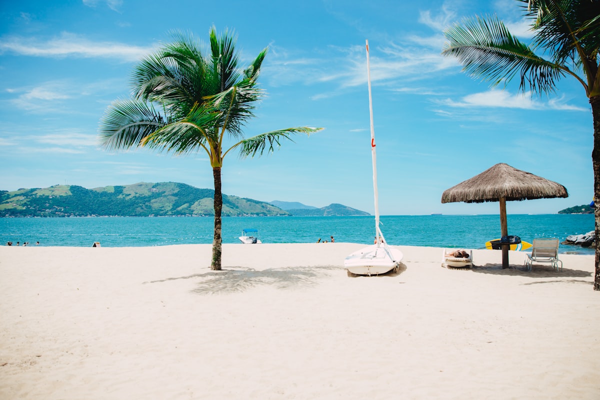 Superyacht anchored near a tropical South Pacific island with coral reefs