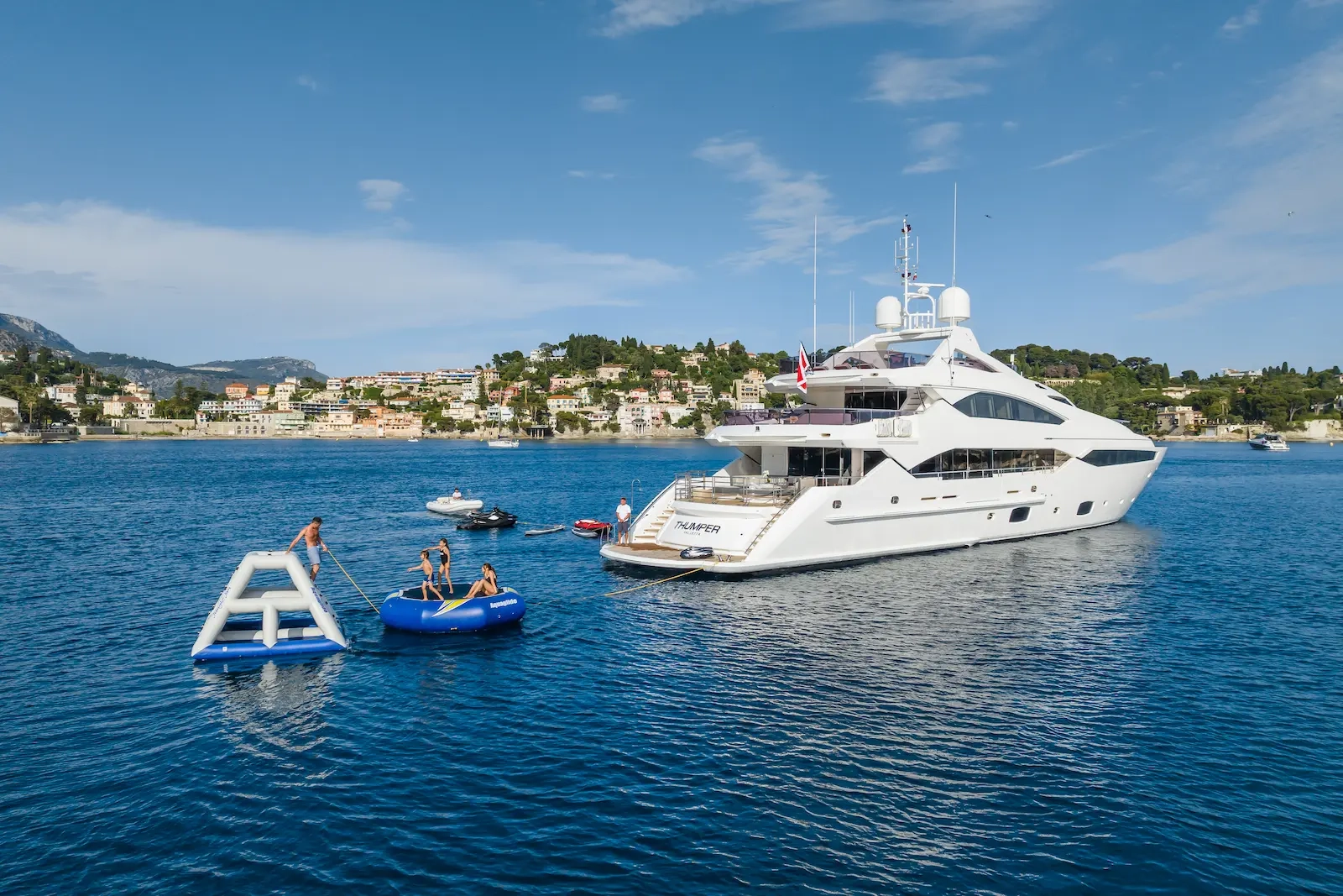 Aerial view of a luxury yacht rental with water toys deployed on the French Riviera