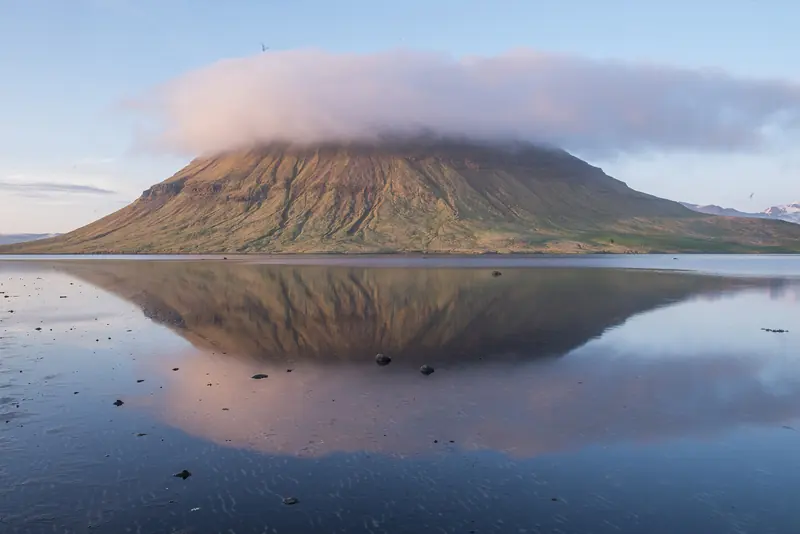 Kirkjufell mountain reflected in still water on the Snæfellsnes peninsula, Iceland