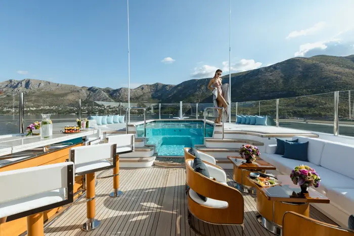 Pool and bar on the sundeck of a superyacht at anchor