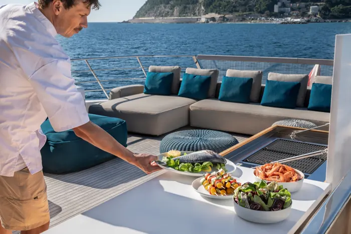 Private chef grilling on deck for guests