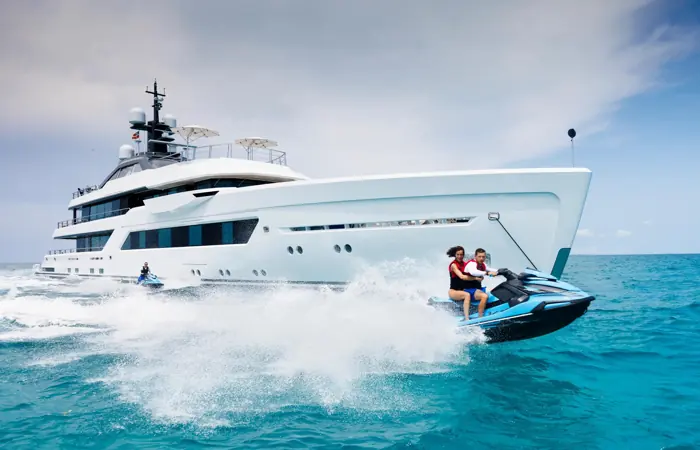 Jet ski crossing the wake of a superyacht under way