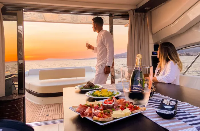 Sunset dinner served on the aft deck of a yacht