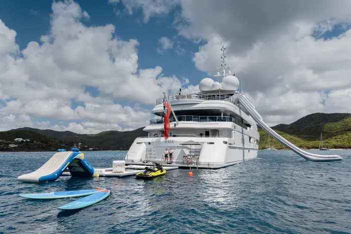 Superyacht at anchor with slide and water toys deployed